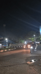 Nighttime street activity captured at Lhokseumawe intersection