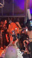 Woman performs on stage to recording audience in Paris