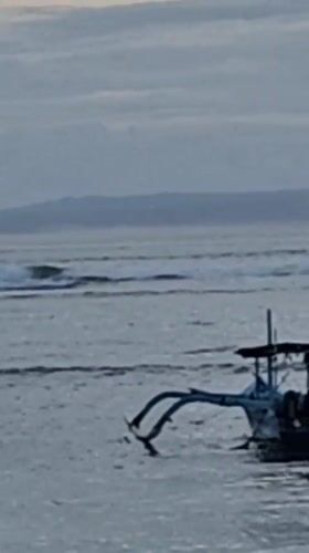 Community beach cleanup documented in Denpasar at dusk