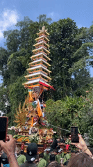 Balinese cremation tower procession winds through Pejeng streets