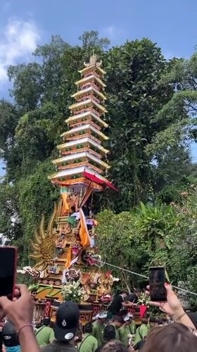 Balinese cremation tower procession winds through Pejeng streets