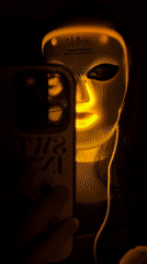 Person documents LED light therapy session with smartphone