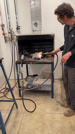 Metal worker creates rainbow effect with torch in Jerusalem