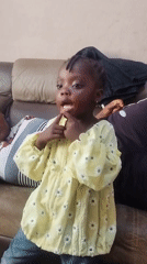 Family relaxes together on couch in Jos home