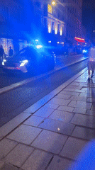 Police car rolls through Paris streets on Bastille Day night