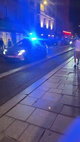 Police car rolls through Paris streets on Bastille Day night