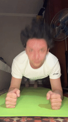 Man exercises indoors during evening workout session in Tashkent
