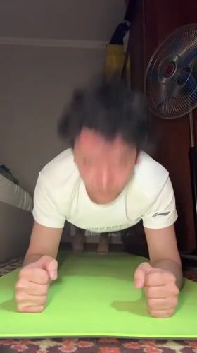 Man exercises indoors during evening workout session in Tashkent