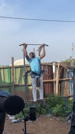 Men conduct outdoor weightlifting session in Akwanga yard