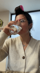 Woman enjoys kitchen moment with drink and food in Puebla