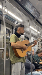 Street musician performs guitar on Buenos Aires subway
