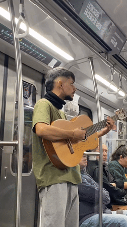 Street musician performs guitar on Buenos Aires subway