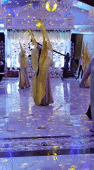Dancers in gold wing costumes perform at a lavish formal reception