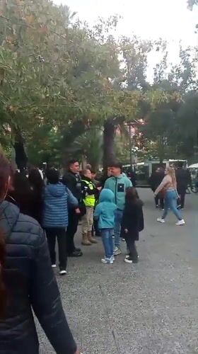 Evening crowd gathers in Santiago public square near statue