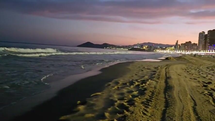 Evening beachfront leisure documented in Benidorm, Spain