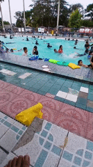 Crowded public pool day in Pangkalpinang under cloudy skies
