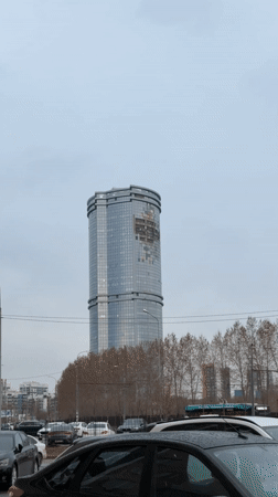 Glass tower observed under overcast skies in Kazan