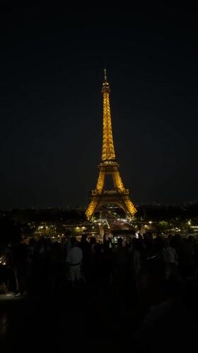Eiffel Tower glowing gold against the Paris night sky