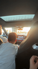Driver and boy in white shirt captured in Rome vehicle