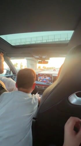 Driver and boy in white shirt captured in Rome vehicle