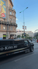 Limo service drives through Budapest with passengers on roof