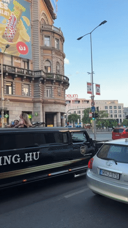 Limo service drives through Budapest with passengers on roof