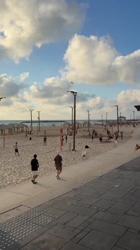 Tel Aviv beachfront buzzing on a sunny June afternoon