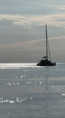 Peaceful coastal scenes documented in Divnomorskoe featuring catamaran and cliffs