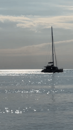 Peaceful coastal scenes documented in Divnomorskoe featuring catamaran and cliffs