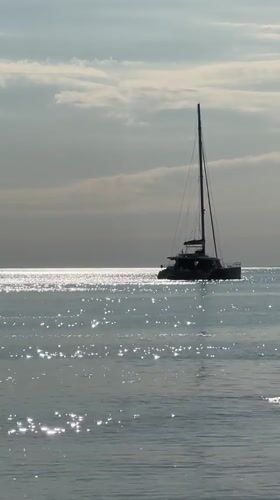 Peaceful coastal scenes documented in Divnomorskoe featuring catamaran and cliffs