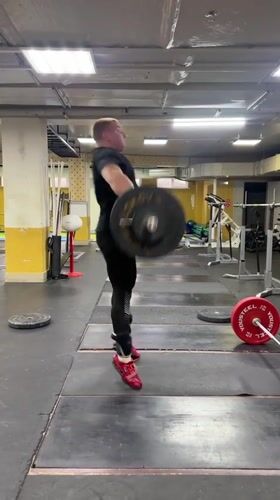 Weightlifter performs barbell snatch at Blagoveshchensk gym
