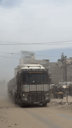 Commercial truck navigates dusty Gaza street conditions