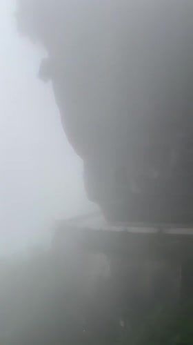 Tourists in life vests navigate foggy Zhangjiajie mountain roads