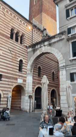 Outdoor dining and crowds fill a Verona piazza