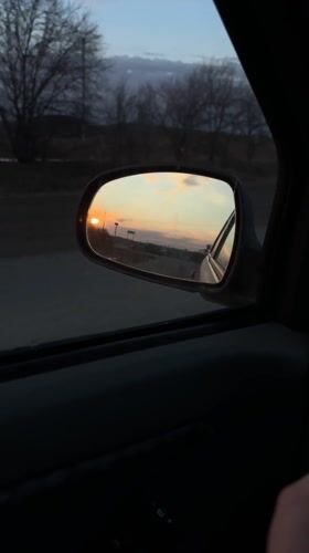 Vehicle travels Russian road at sunset near Rusalevka
