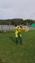 Beekeeper tends hives in protective gear in Markovo