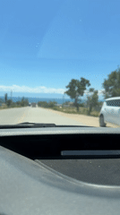 Road trip through mountain and lake scenery on a clear day