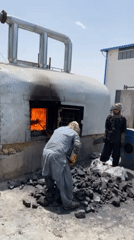 Workers operate industrial furnaces at Kandahar facility