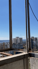 Construction site overlook captures cityscape view through metal framework