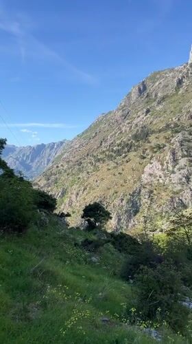Tourist documents scenic mountain views in Kotor, Montenegro