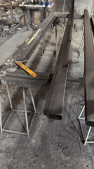 Spray painting a metal object in a Baku workshop