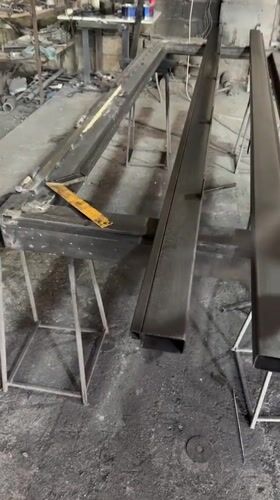 Spray painting a metal object in a Baku workshop