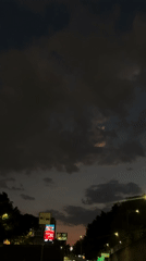 Nighttime drive captured through Mexico City streets under cloudy skies