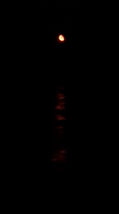 Crescent moon observed over beach with heart structure