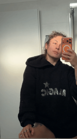 Woman takes bathroom mirror selfie in Kiryat Bialik