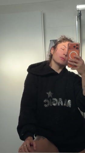 Woman takes bathroom mirror selfie in Kiryat Bialik