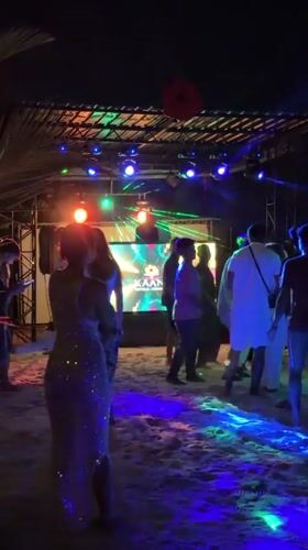 Beach party with stage lights draws dancers in Maldives