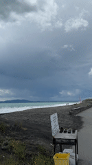 Morning beachgoers enjoy cloudy coastline in Burgas, Bulgaria