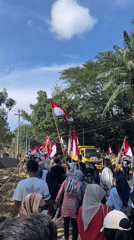 Flag-carrying procession through rural Indonesian streets