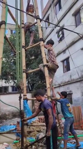 Bamboo scaffolding and drilling work at a Dhaka construction site